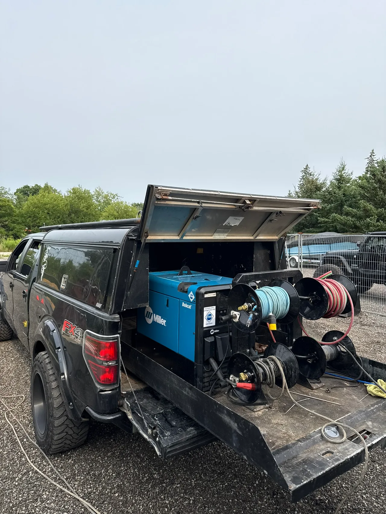 Mobile welding truck with a Miller Bobcat engine-driven welder and cable reels
